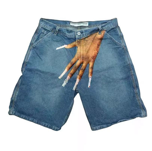 SWAGTOK light blue denim shorts with a graphic print of a hand with long, decorated nails on the right leg.