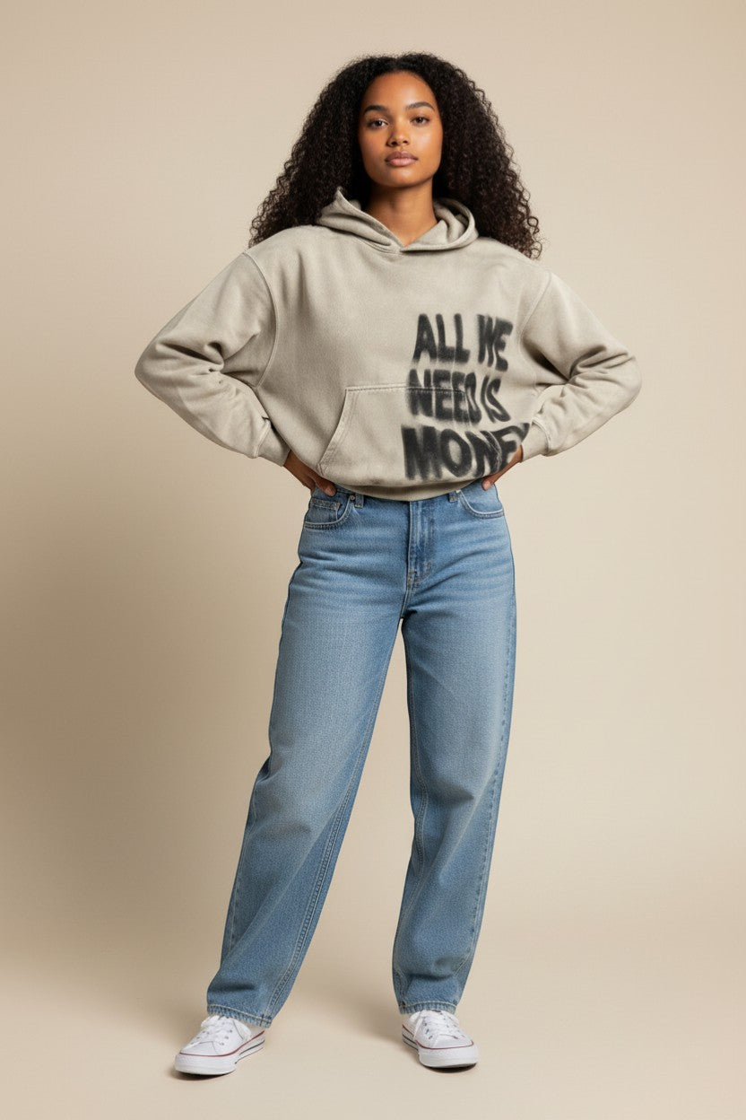 SWAGTOK beige loose fit pullover hoodie with "ALL WE NEED IS MONEY" graphic print and front pocket. Made of polyester.