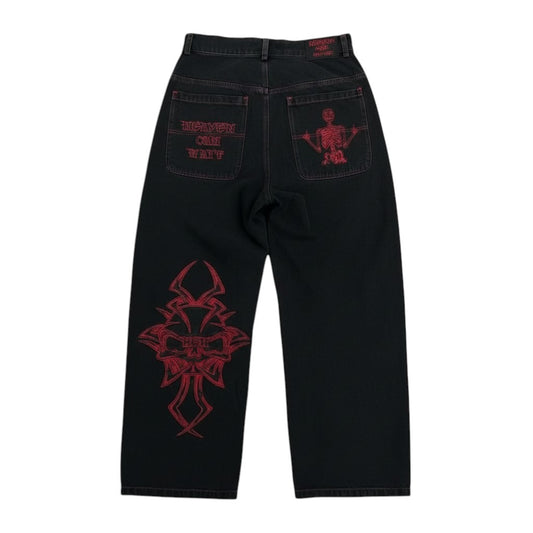 SWAGTOK black cotton straight-leg pants with red skull embroidery on leg and back pocket.