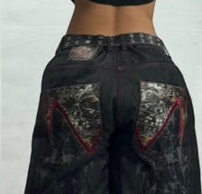 SWAGTOK men's black wide-leg denim jeans with distressed wash and unique graphic back pockets.