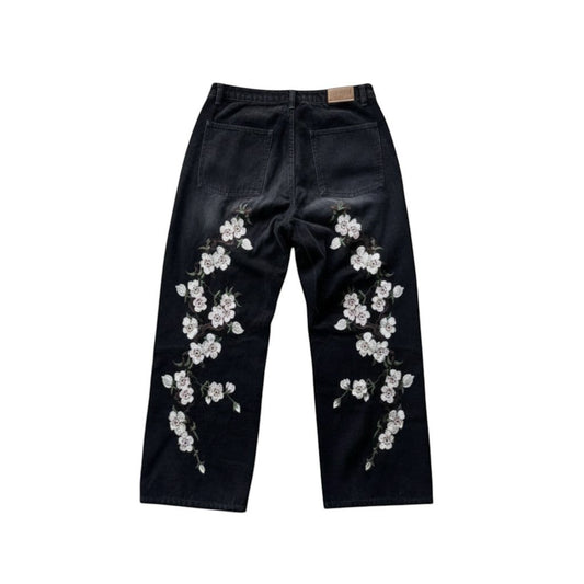 SWAGTOK black denim straight-leg trousers with embroidered white flowers on legs. Casual summer style.