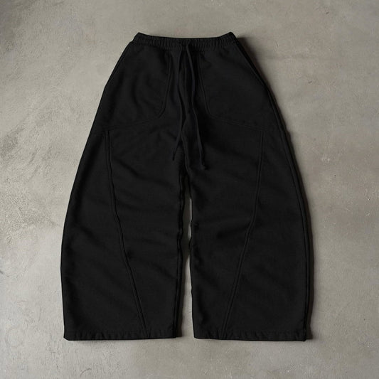 SWAGTOK black cotton wide-leg sweatpants with drawstring waist and embroidered detail.
