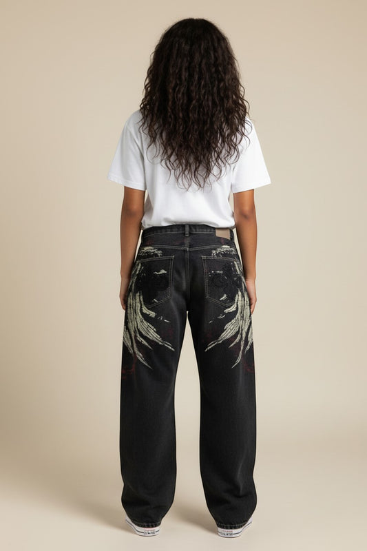 SWAGTOK men's loose fit black denim jeans with embroidered wing design and red accents.