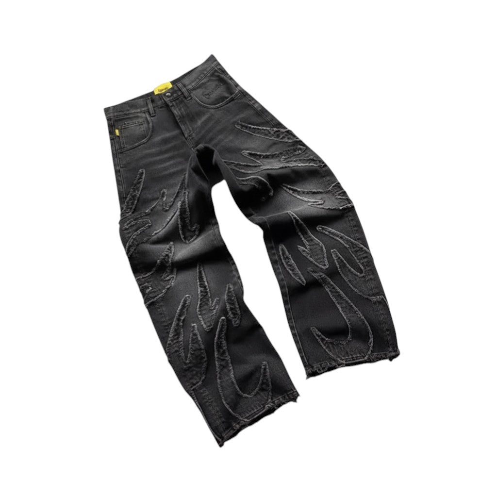 SWAGTOK black cotton straight leg jeans with flame embroidery and distressed hem.