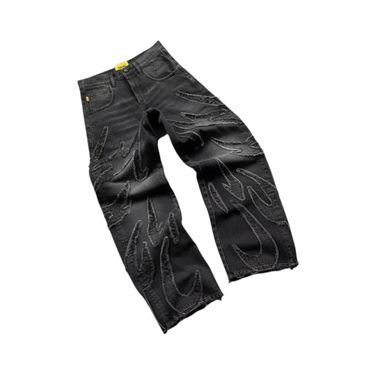 SWAGTOK black cotton straight leg jeans with flame embroidery and distressed hem.