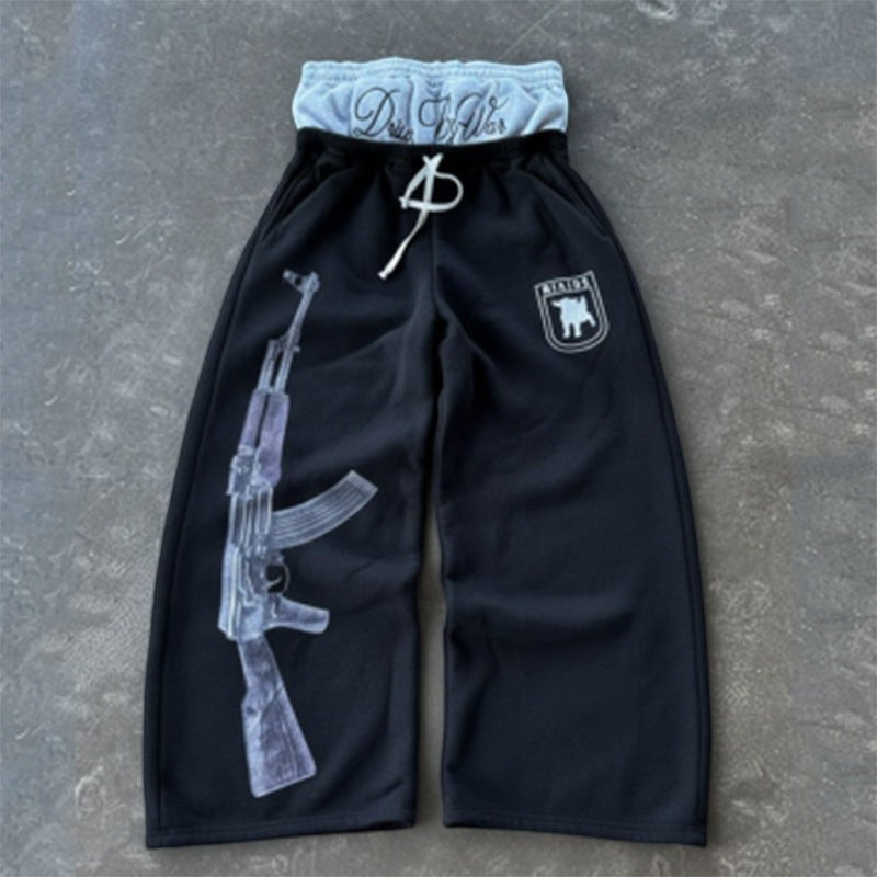 SWAGTOK black polyester sweatpants with double waistband, drawstring, AK-47 graphic print, and embroidered logo.