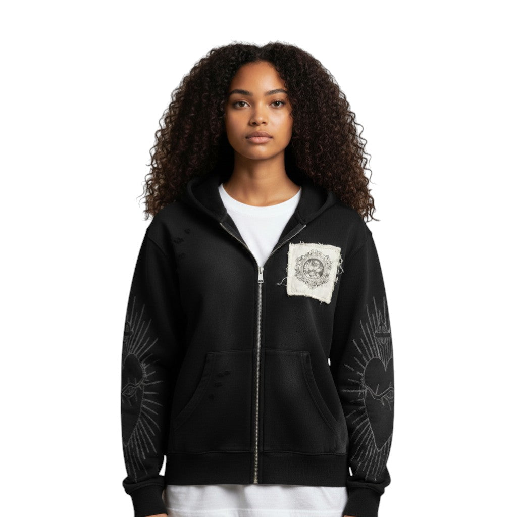 SWAGTOK black zip-up hoodie with distressed details, a chest patch, and embroidered sacred heart graphics on the sleeves.