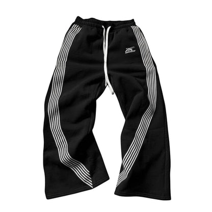 SWAGTOK black fleece-lined sports pants with embroidered white stripes and drawstring waist.