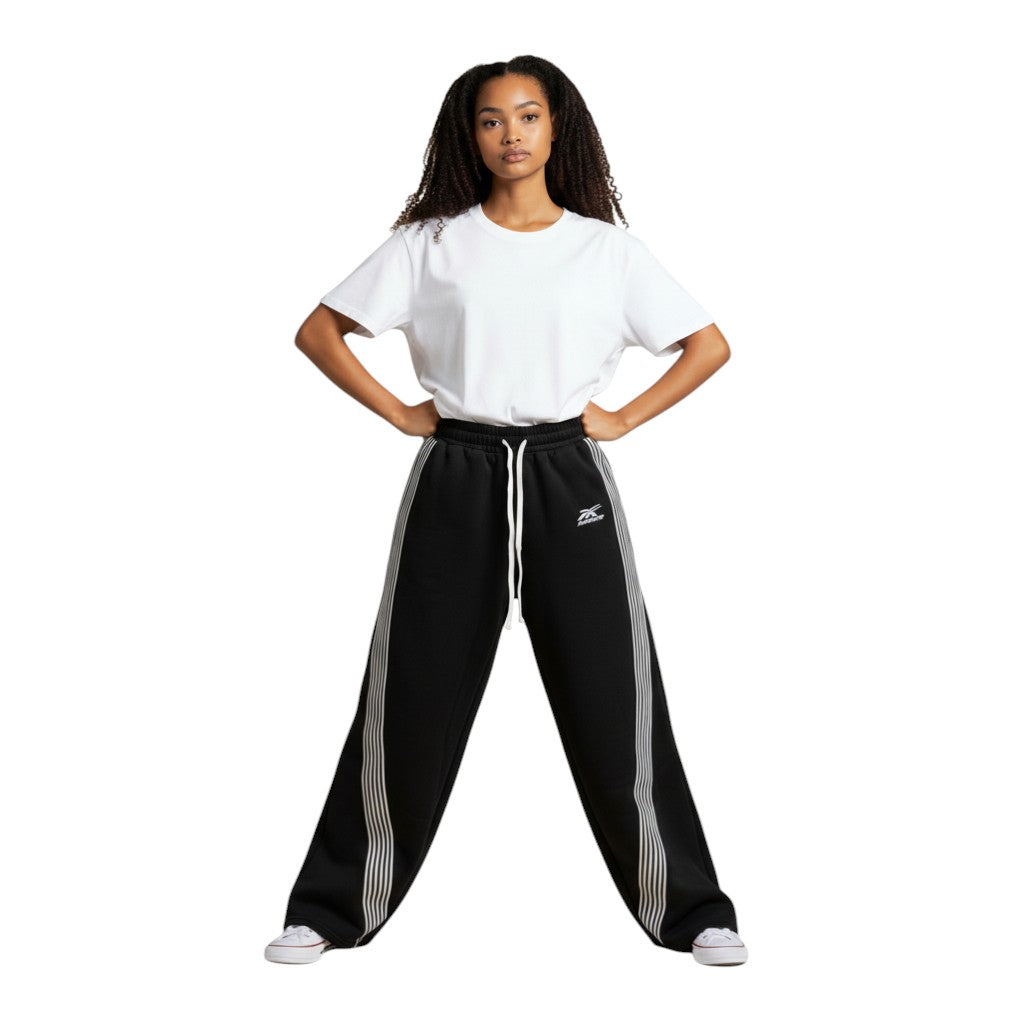 SWAGTOK black polyester blend sweatpants with white side stripes and drawstring waist. Features batwing sleeves and Harajuku style.