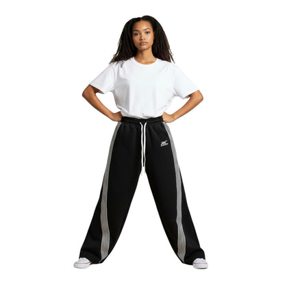 SWAGTOK black polyester blend sweatpants with white side stripes and drawstring waist. Features batwing sleeves and Harajuku style.