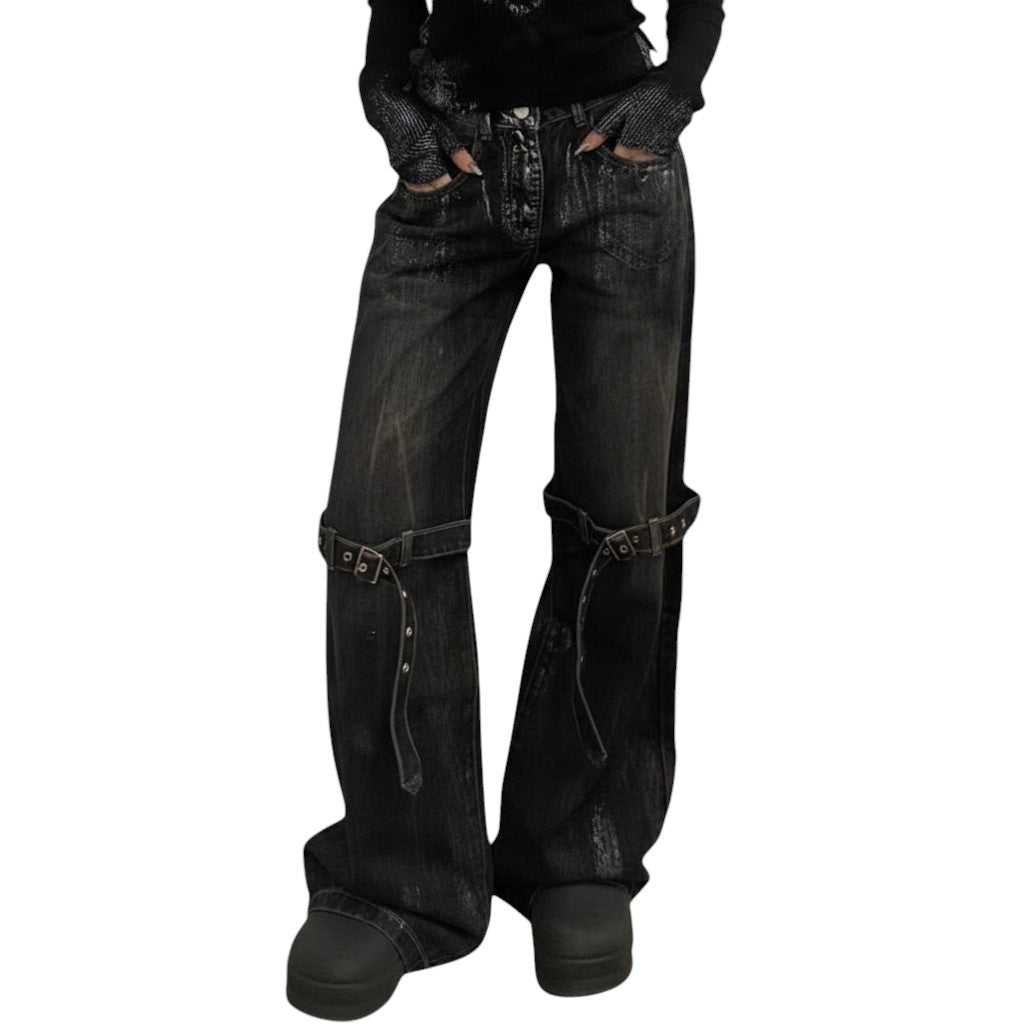 SWAGTOK black deconstructed wide-leg denim jeans with lace-up detailing and adjustable straps.