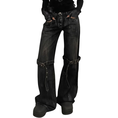 SWAGTOK black deconstructed wide-leg denim jeans with lace-up detailing and adjustable straps.