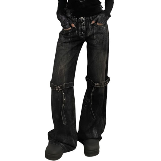 SWAGTOK black deconstructed wide-leg denim jeans with lace-up detailing and adjustable straps.