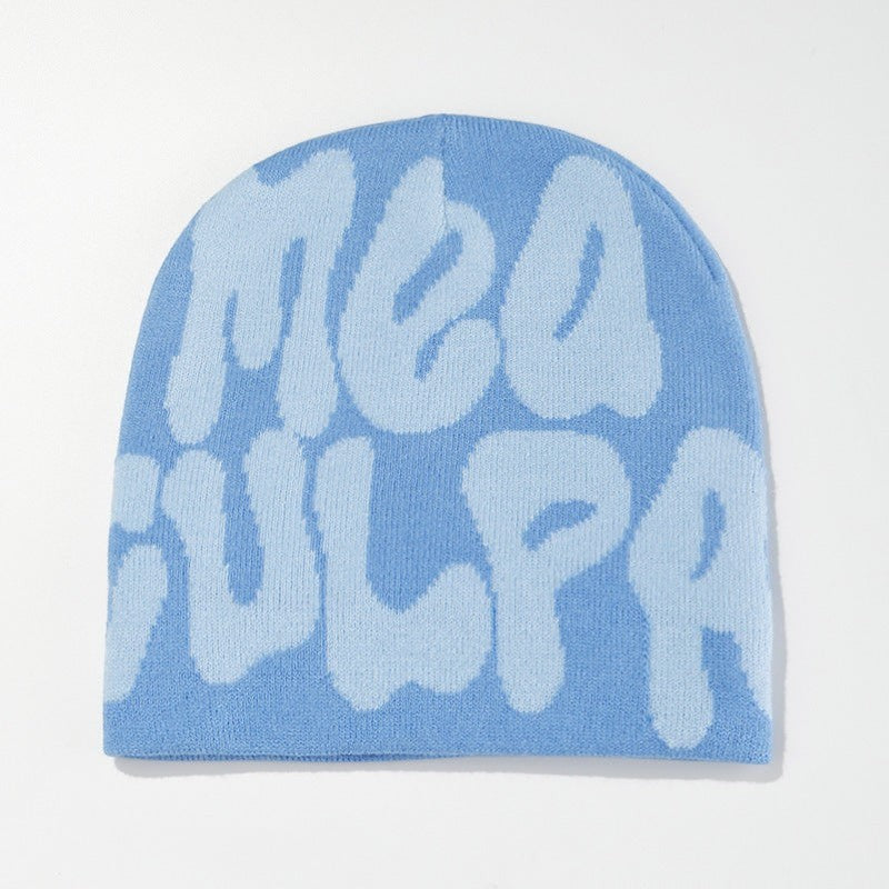 SWAGTOK light blue acrylic knit beanie with contrasting light blue bubble lettering spelling 'mea gulpa'. Machine embroidered.