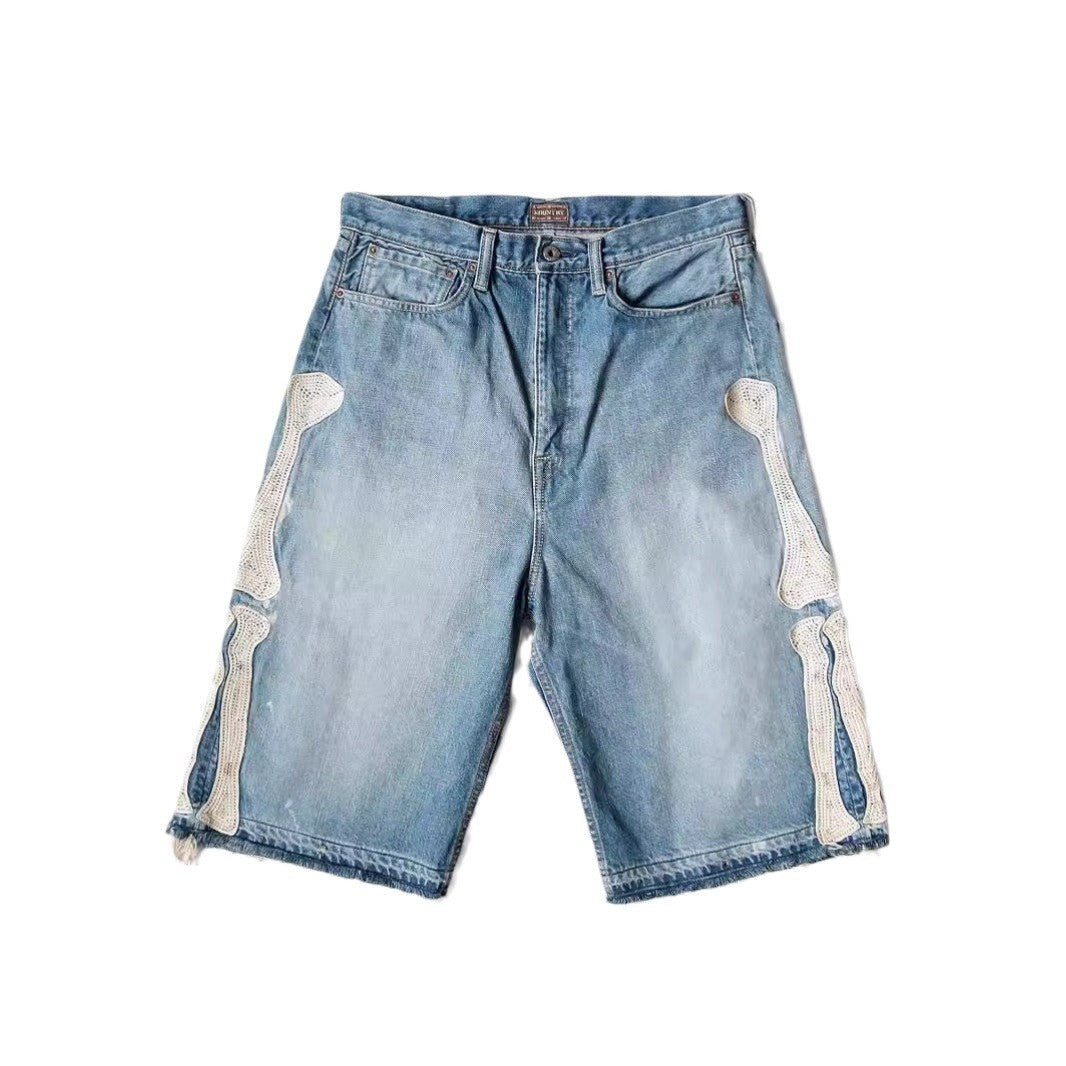 SWAGTOK light blue denim shorts with white embroidered bone details on the sides, straight leg, summer hip hop style.