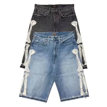 SWAGTOK blue denim shorts with embroidered bone graphic detail and frayed hem. Hip hop style.