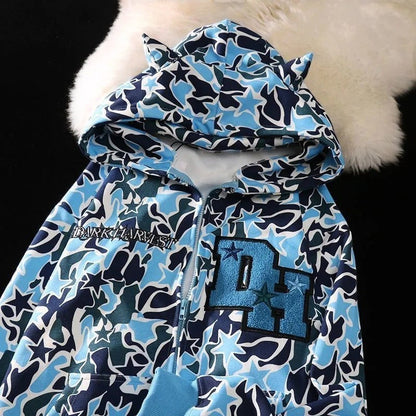 SWAGTOK blue and pink camouflage print zip-up hoodie with star pattern and embroidered 'DH' logo.