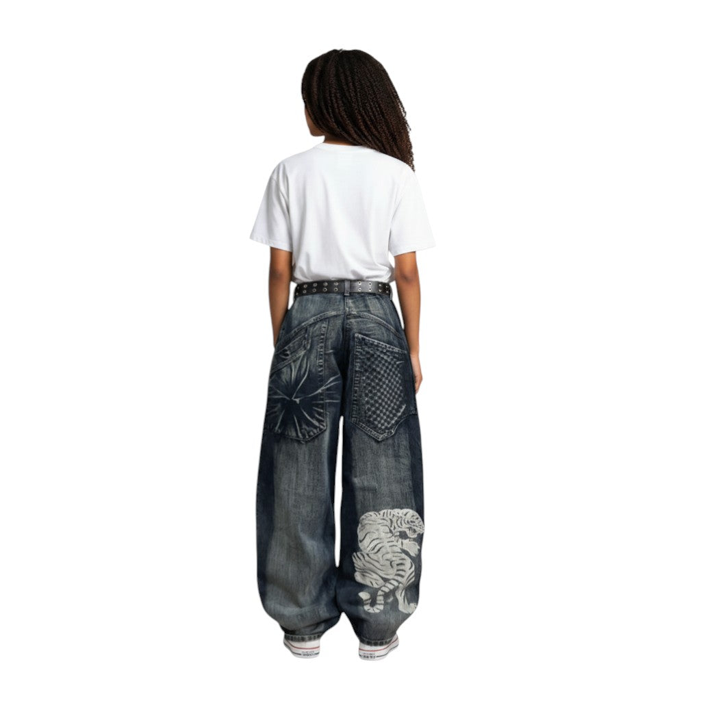 SWAGTOK blue denim wide leg jeans with high waist and white tiger print on the leg.