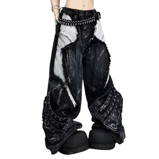 SWAGTOK black and blue deconstructed denim jeans with distressed details and grommets. Mid-rise, full-length.