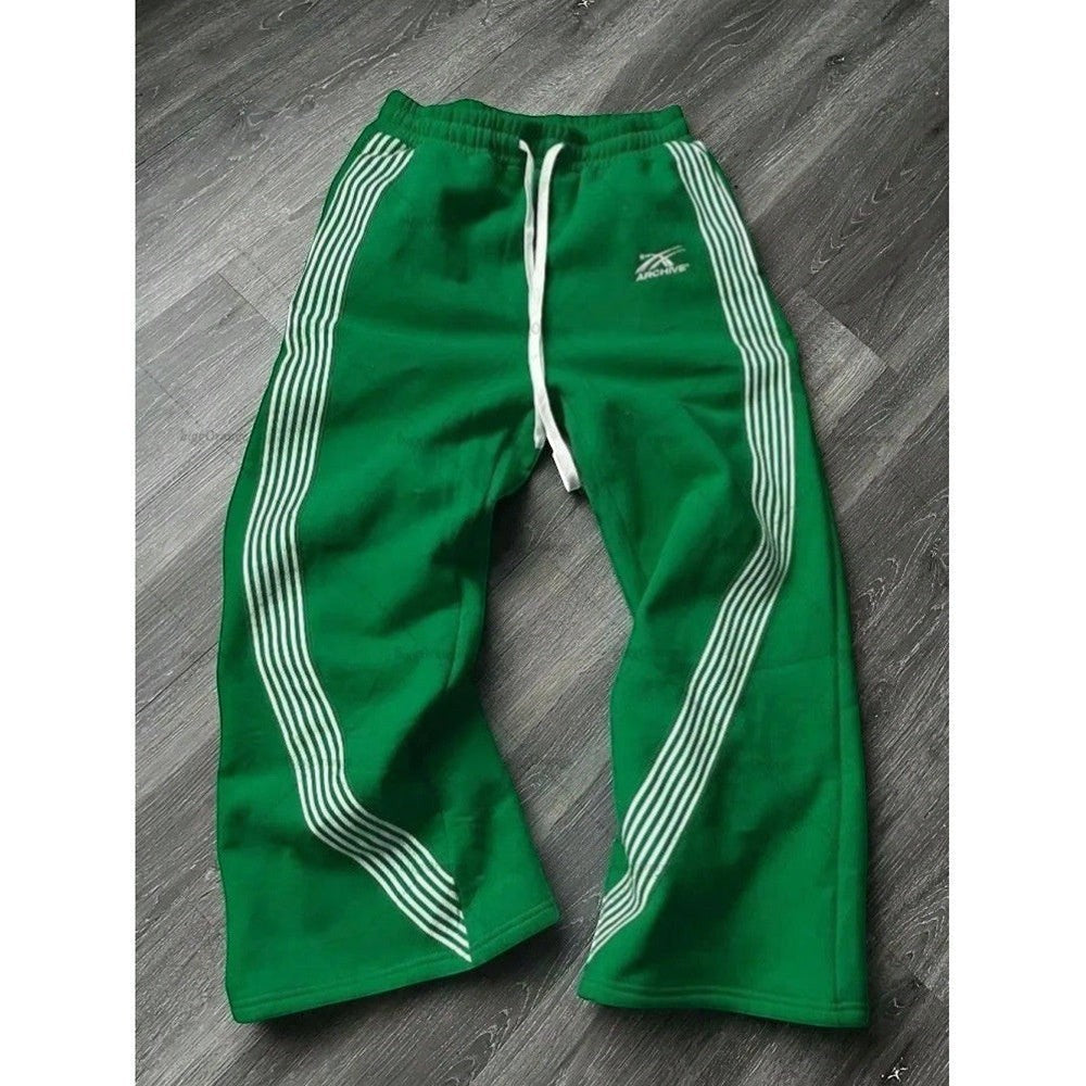 SWAGTOK green fleece sports pants with white embroidered stripes and drawstring waist.