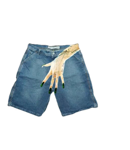 SWAGTOK light blue denim shorts with a graphic print of a hand with green nails on the right leg. Low waist, straight fit, zip fly.