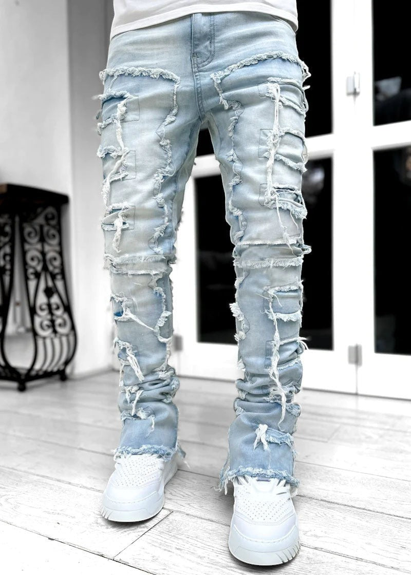 SWAGTOK light blue distressed denim jeans with patchwork and fringe details, stacked fit for men.