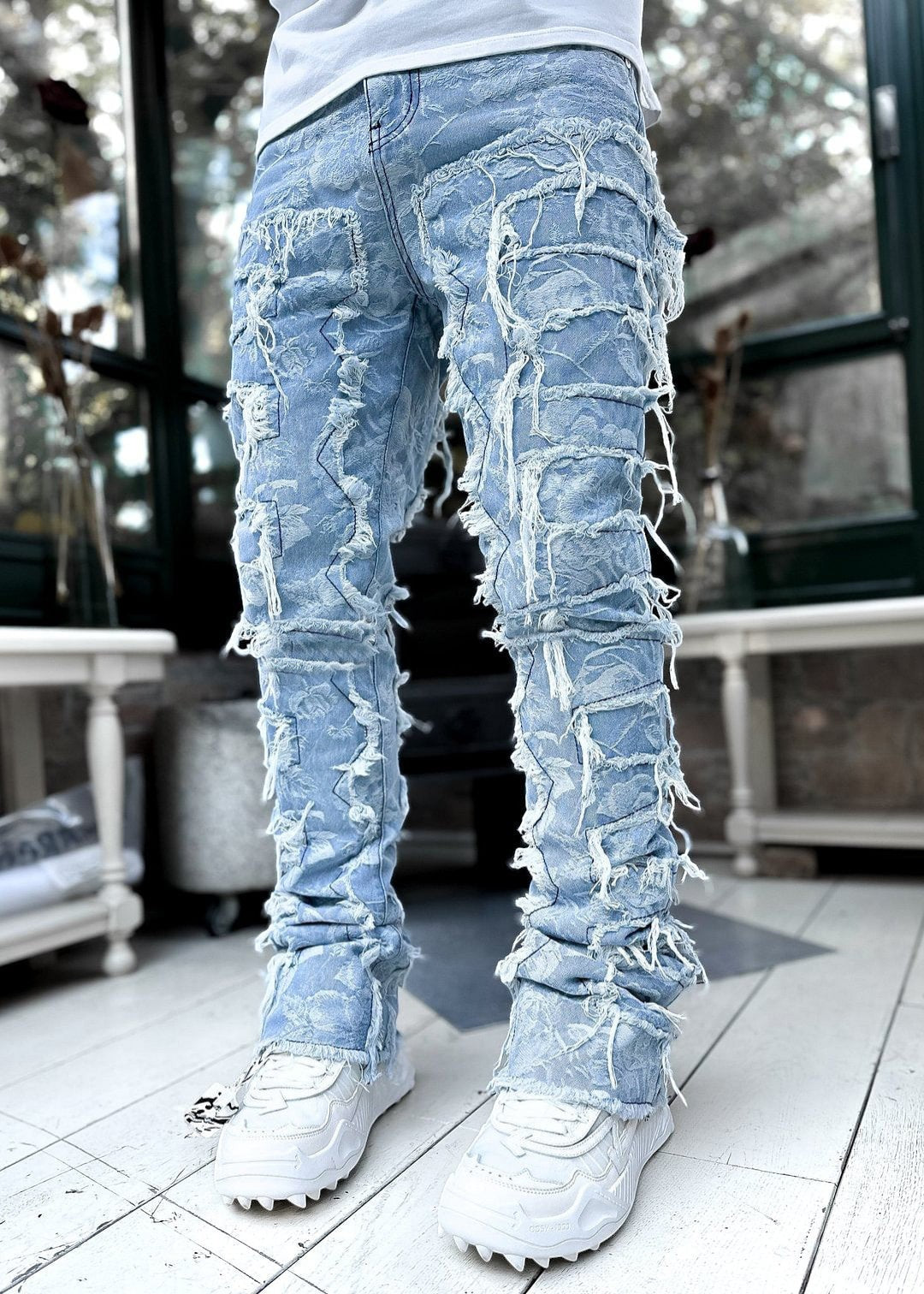 SWAGTOK light blue distressed denim jeans with patchwork and frayed details, tight fit, stacked leg.