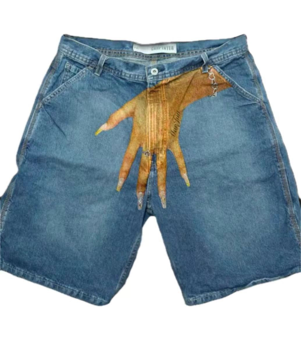 SWAGTOK light blue denim shorts with a graphic print of a hand with long nails on the front. Low waist, straight leg, zip fly.