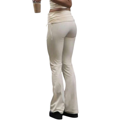 SWAGTOK light yellow low-waist bootcut trousers made of knitted polyester with lace-up detail.