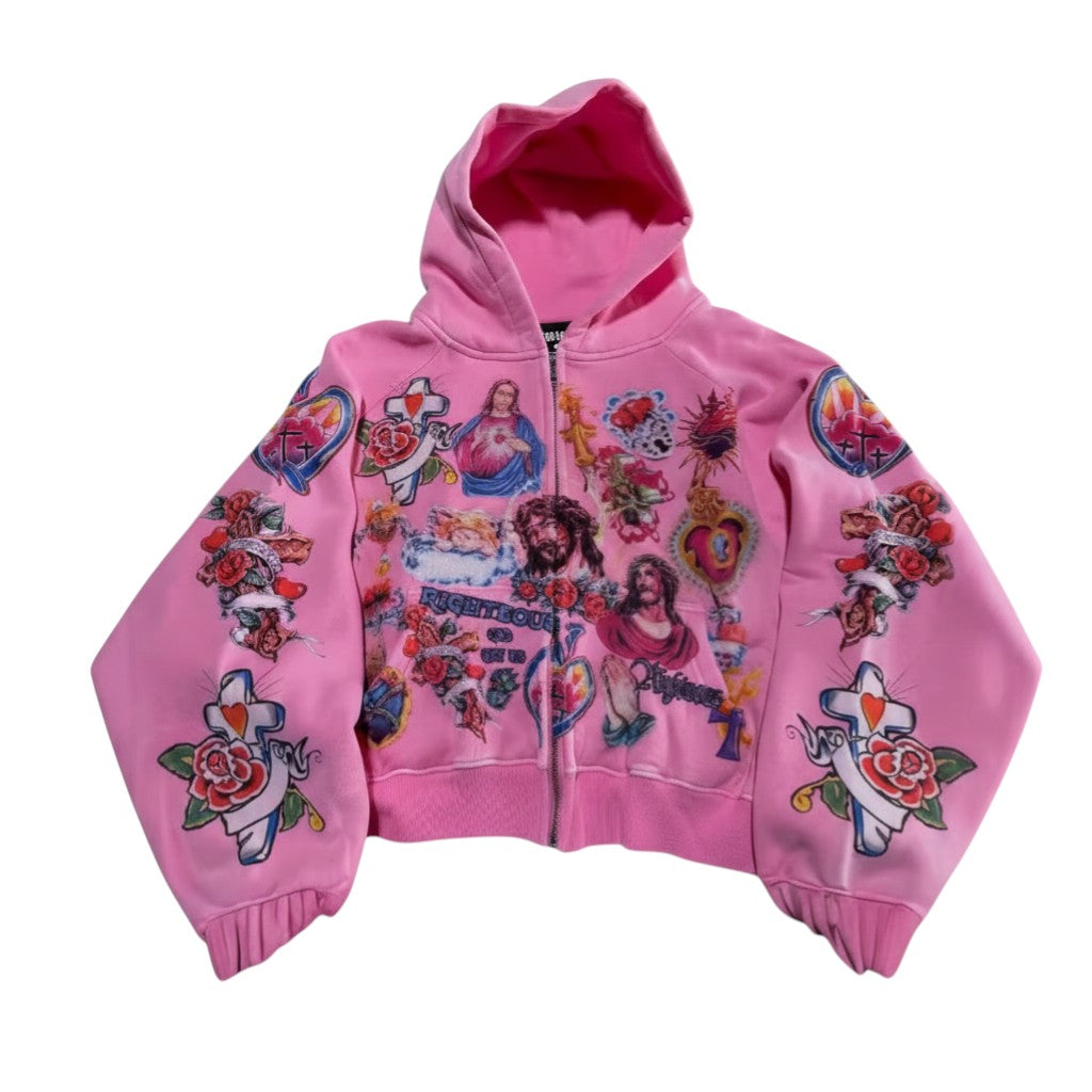SWAGTOK pink polyester zip-up hoodie with religious and tattoo-style graphic prints on sleeves and front.