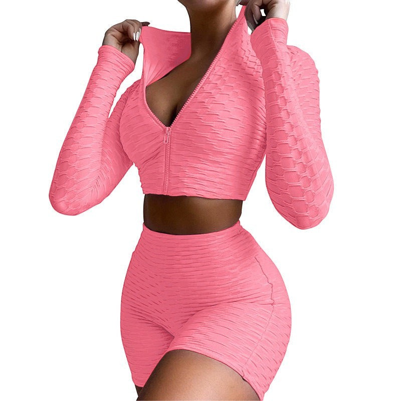SWAGTOK pink textured polyester long sleeve zip-up crop top and high-waisted shorts activewear set.