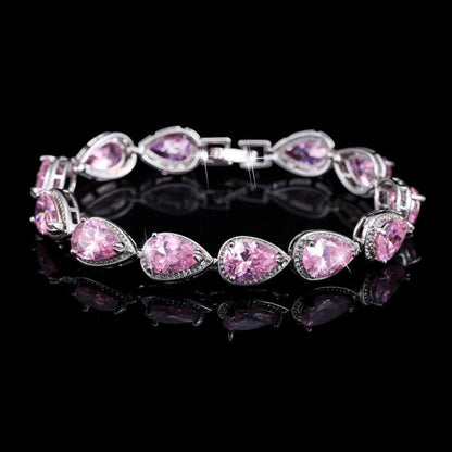 SWAGTOK platinum plated bracelet with pink drop-shaped zircon stones and geometric clasp.