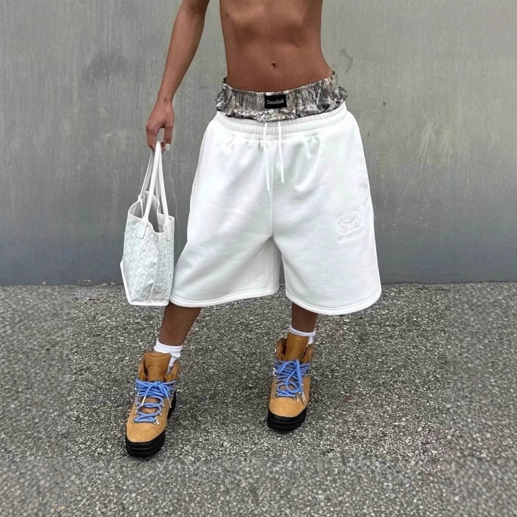 SWAGTOK white cotton cropped wide-leg shorts with drawstring waist and embroidered logo detail.
